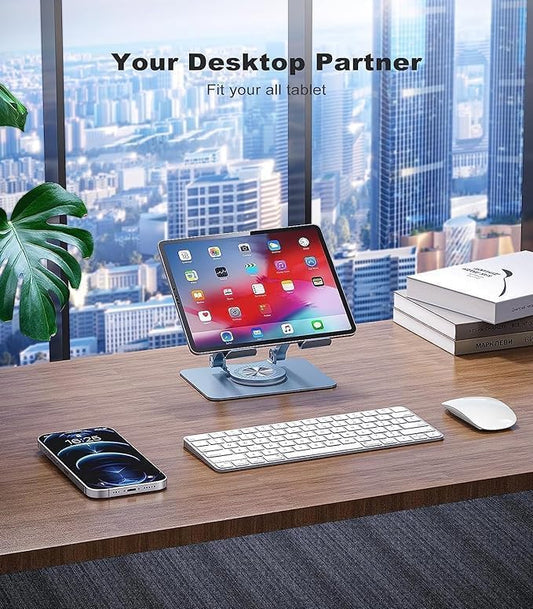 Tablet stand on a desk with tablet, keyboard, phone, and mouse in an office setting.